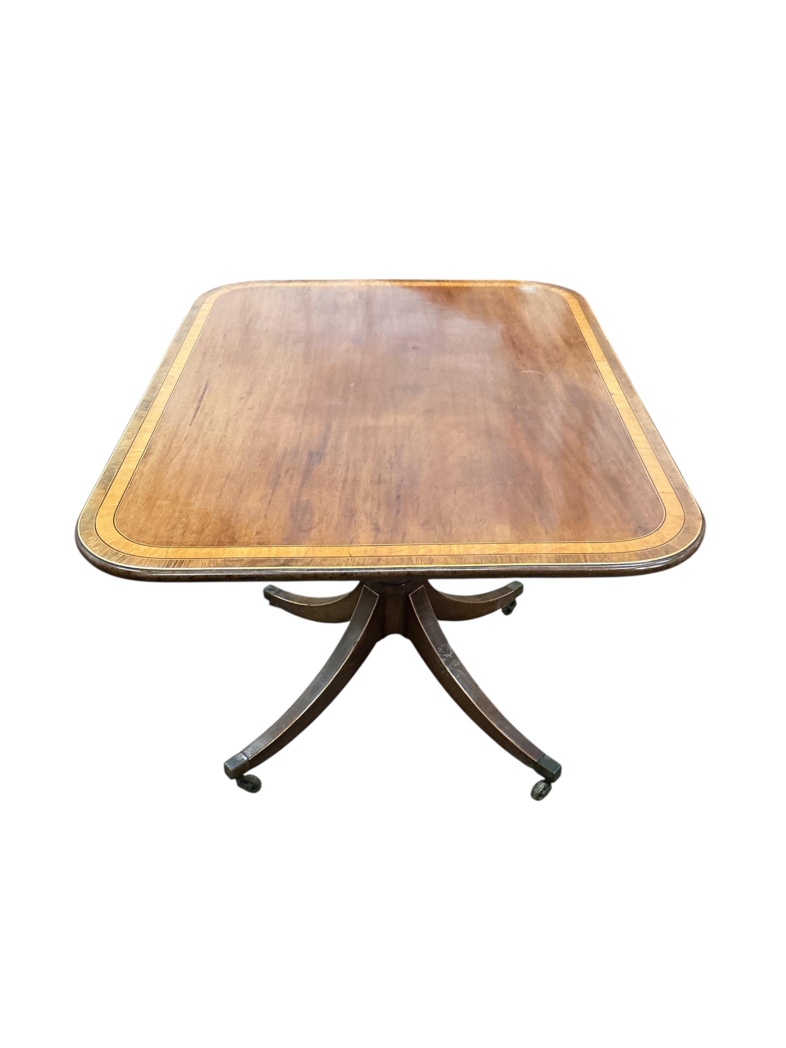 A Regency satinwood banded rectangular mahogany tilt top dining table, on four outswept legs, width 82cm, depth 104cm, height 72cm